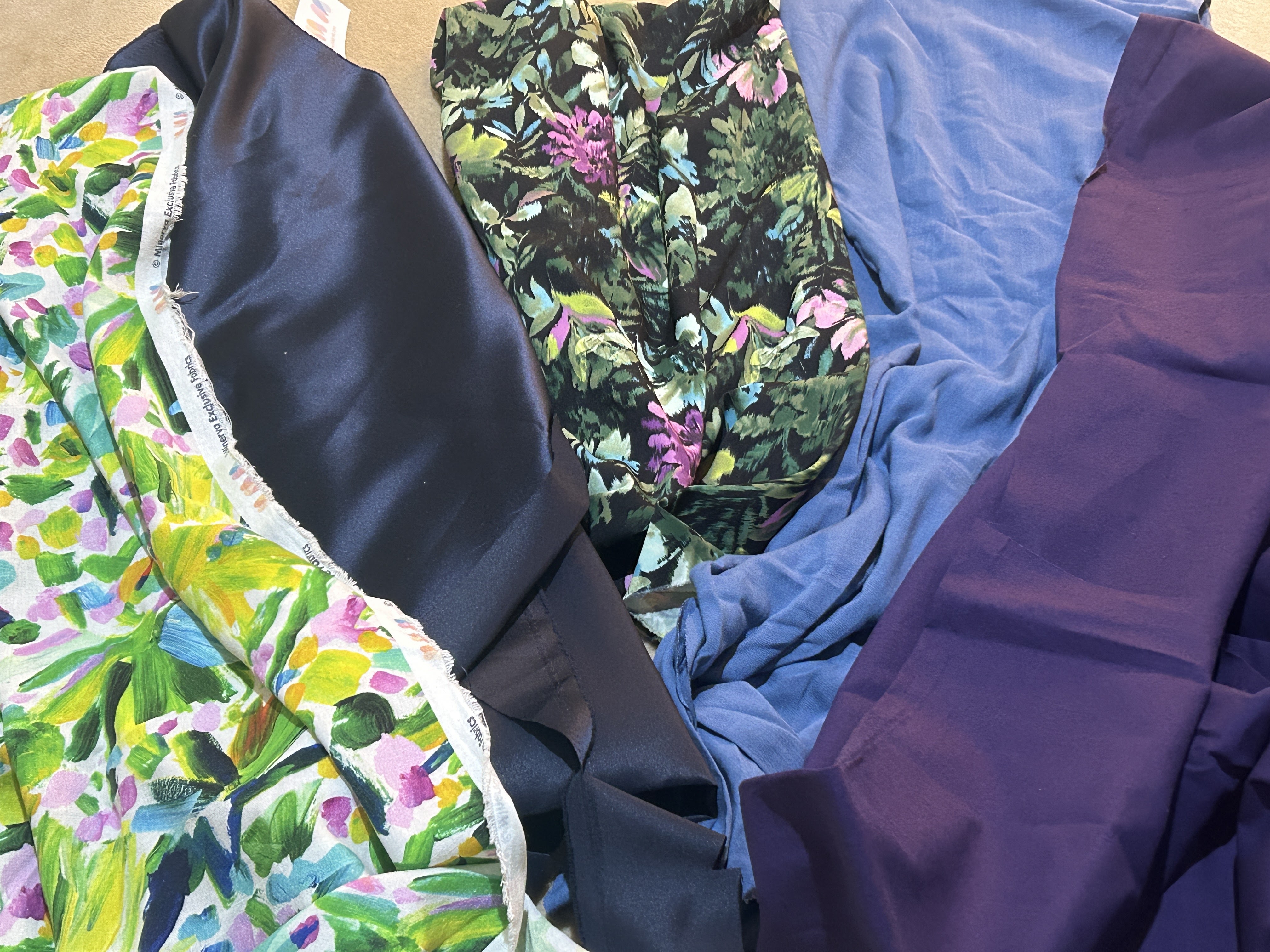 5 fabrics laid out on the floor